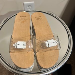 Dr. Scholl’s x Urban Outfitters clear wooden sandals.